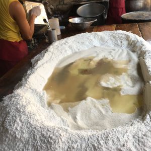 large pile of flour with crater of boiling water