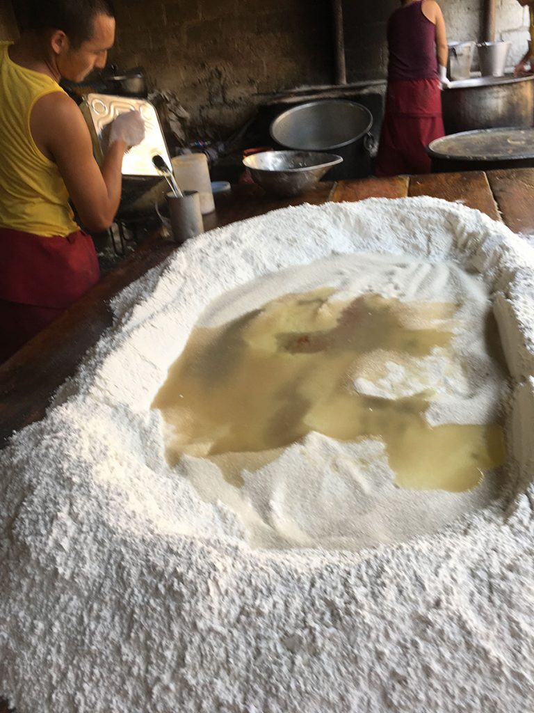 large pile of flour with crater of boiling water