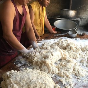 2 men kneading the dough