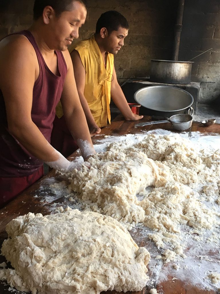 2 men kneading the dough