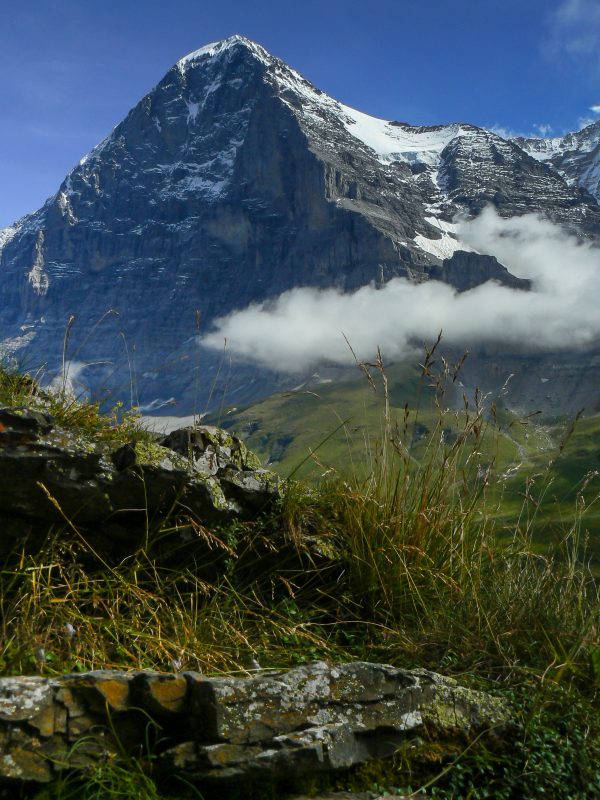 view of snow capped mountain with cloud in front